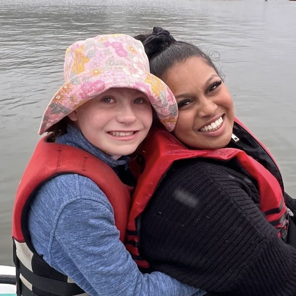 Divya with a participant out on the water in life jackets