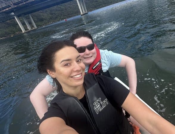 Two people out on the water together, mid-laugh